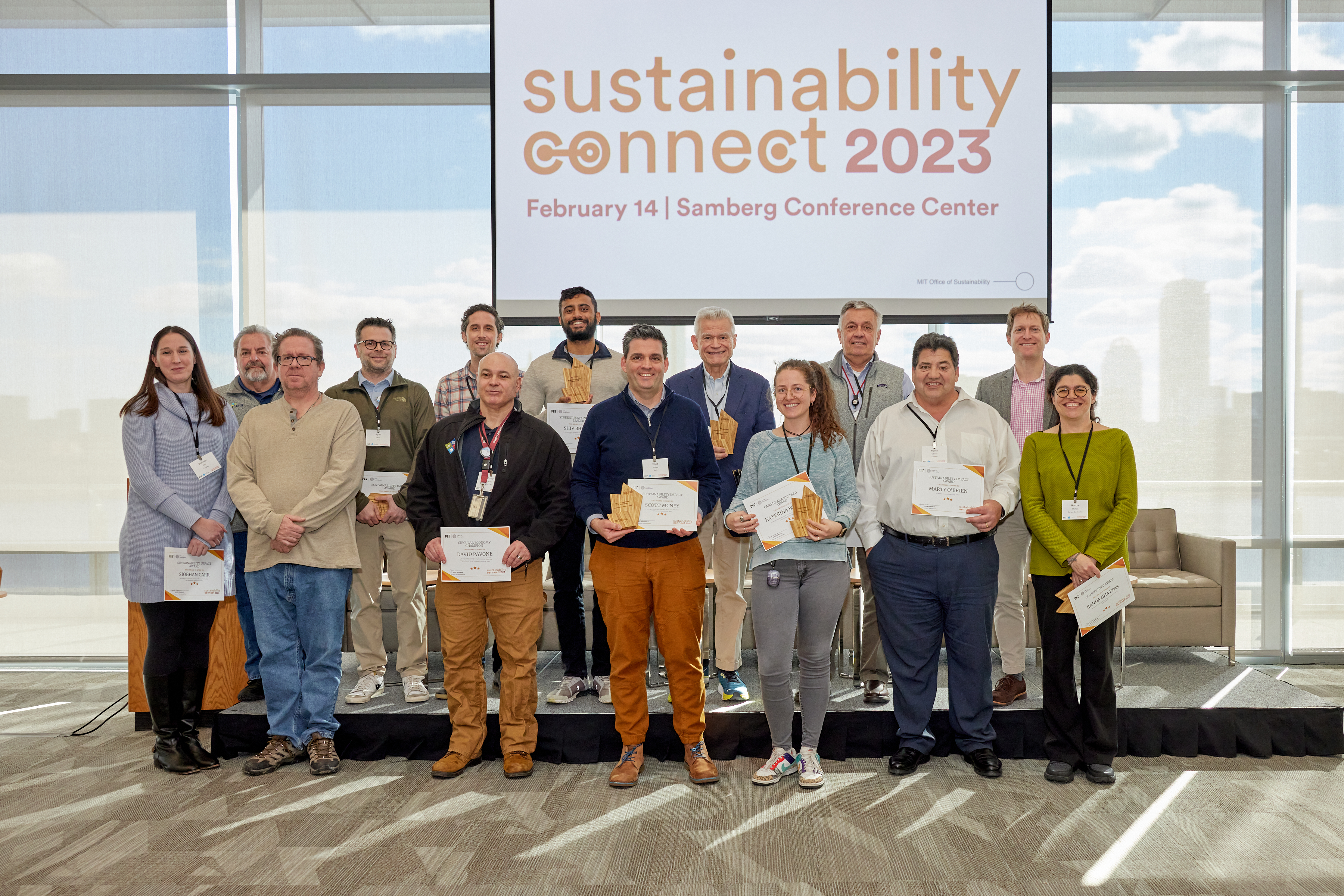 group of people holding award certificates