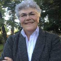 headshot of white woman in suit coat