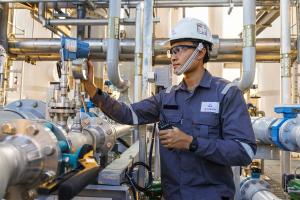 The mission of Gradiant, a firm started by MIT alumni, is to preserve water for generations to come in the face of rising global demand through innovation. Here, a worker inspects a Gradiant water treatment system.